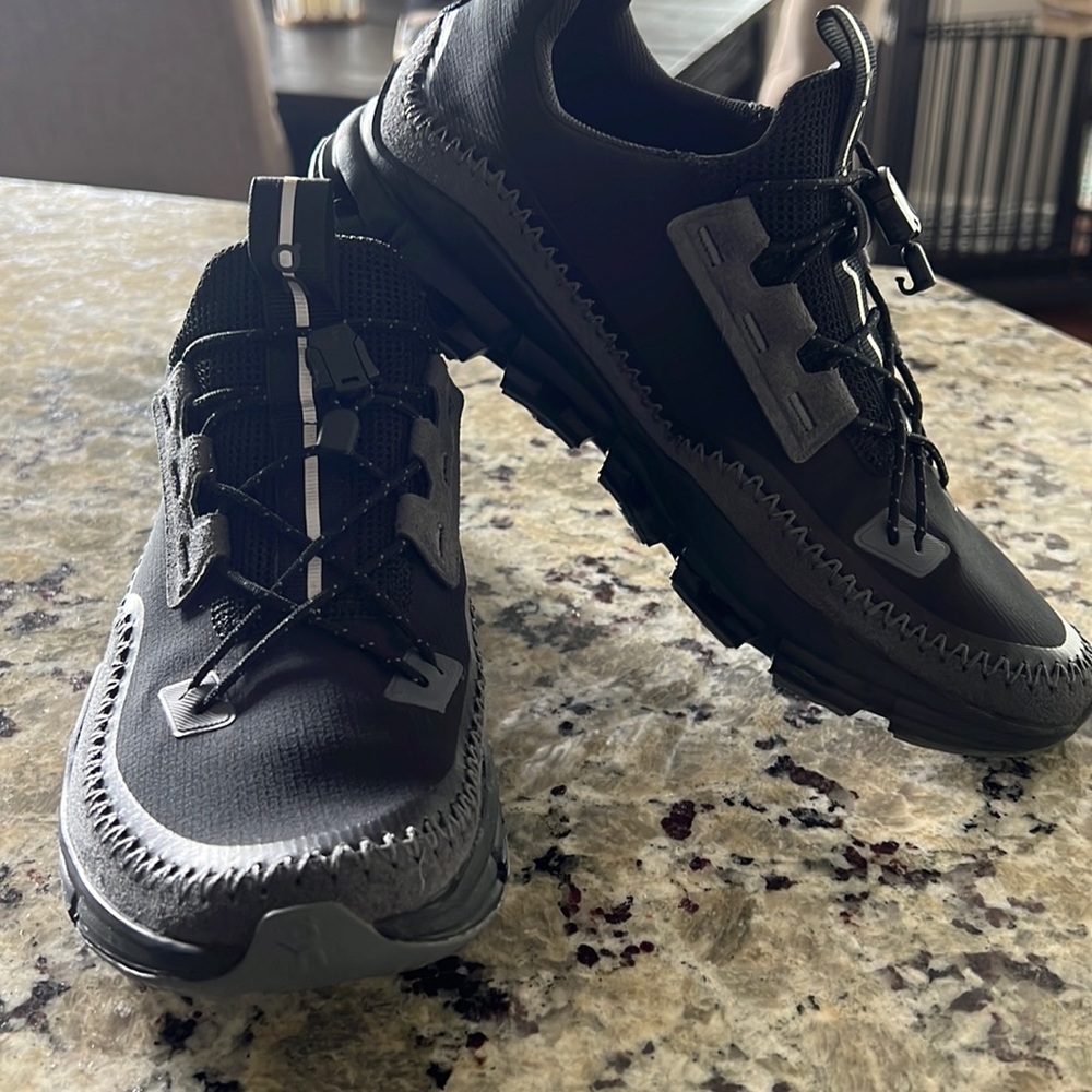Black and gray On cloudaway tennis shoes.